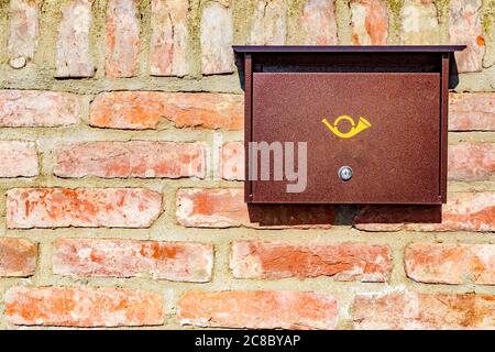 Brown mailbox on brick wall, vintage mailbox style. Stock Photo