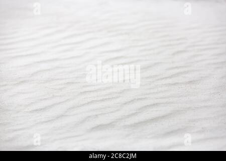 Wavy texture of white sands blown in the wind. Background of white sand nature texture Stock Photo