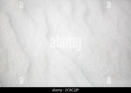 Wavy texture of white sands blown in the wind. Background of white sand nature texture Stock Photo