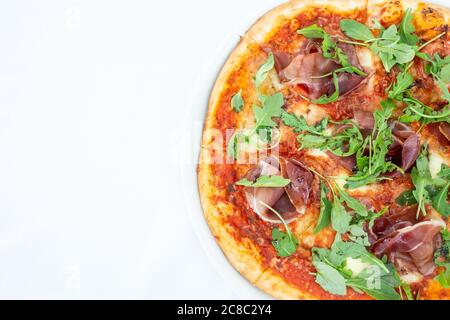Pizza Margarita adorned simply in the colors of the Italian flag green from basil, white from mozzarella, red from tomato sauce, isolated on white Stock Photo