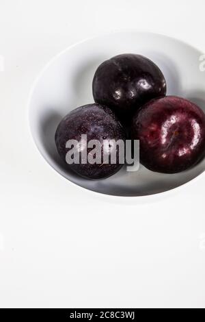Plums in bowl Stock Photo