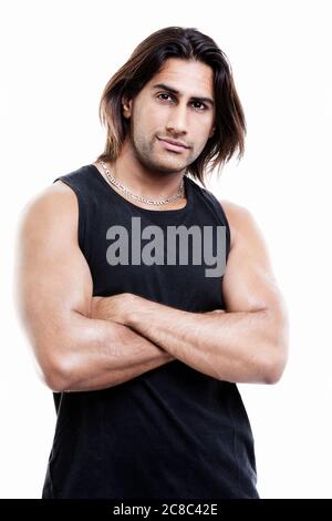 Attractive indian man with arms folded in studio Stock Photo