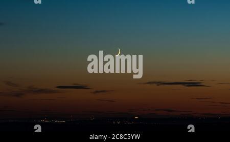 Waxing moon from the South Coast of the United Kingdom looking towards the Sussex city of Brighton. Stock Photo