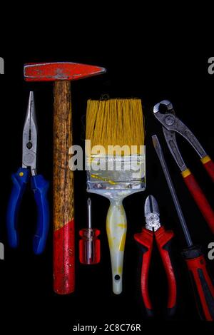 Needle-nose pliers, hammer, screwdriver, Philips screwdriver, color brush and pliers. Stock Photo