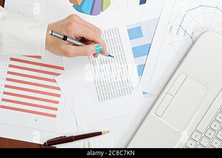 woman is analysing graphs and graphs Stock Photo