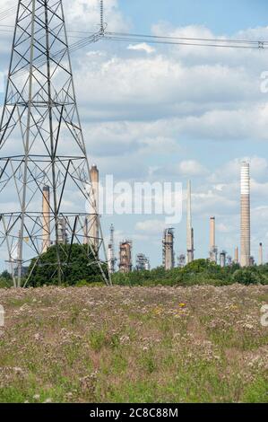 Exxon Mobil oil refinery with cooling towers, stacks and storage tanks ...