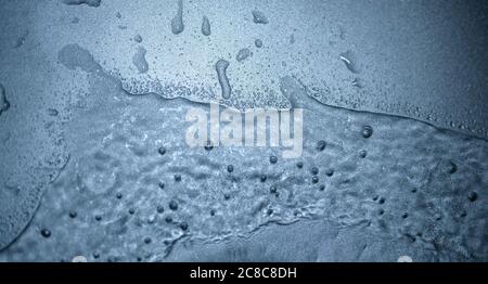 Water drops on metal surface. Macro with shallow depth of field. Stock Photo
