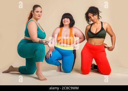 Group of 3 oversize women posing in studio - Beautiful girls accepting body imperfection, beauty shots in studio - Concepts about body acceptance, bod Stock Photo