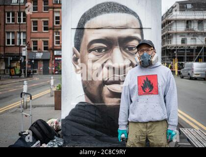 Portrait of Street artist, Akse P19, standing in front of his murals