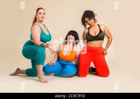 Group of 3 oversize women posing in studio - Beautiful girls accepting body imperfection, beauty shots in studio - Concepts about body acceptance, bod Stock Photo