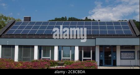 A three-row photovoltaic system built on an office building. Stock Photo