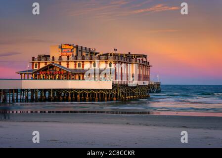 Daytona Beach, Florida, USA - January 8, 2020: Sunset above Daytona Beach Main Street Pier With Joe's Crab Shack restaurant. Stock Photo