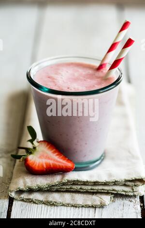 Strawberry smoothie in a glass with paper straws Stock Photo