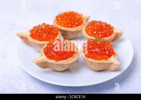 Red caviar (salmon caviar) in tartlets. Selective focus, close-up. Stock Photo