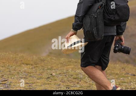 A young man enjoys taking photos in nature on his way to the cold summit of Moncayo, the highest mountain in the Iberian System, in the Tarazona regio Stock Photo
