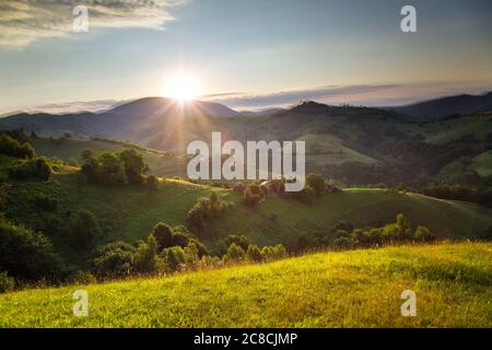 Summer sunrise in the Transylvanian village. Aerial foggy landscape in Transylvania, at sunrise Stock Photo