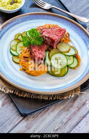 Tasty cooked sweet potato and sauce on wooden background Stock Photo ...