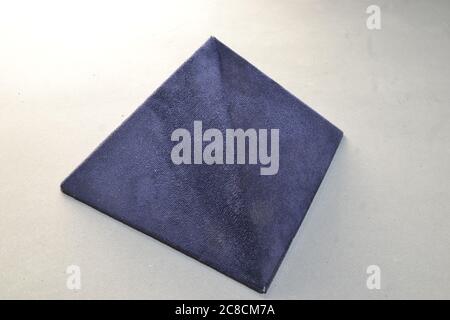 Pyramid. Blue felt pyramid, handmade, handcrafted, textured and photographed on white background, with natural light with copy space, top-down view Stock Photo
