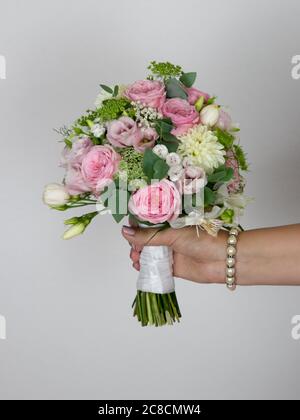 Wedding flowers held in a woman's hand Stock Photo