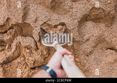 Sand for mortar with a shovel - making concrete screed or plaster - building from stone Stock Photo