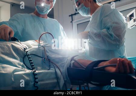 patient lies on the operating surgical table during rhinoplastic operation surgery with anesthesia Stock Photo