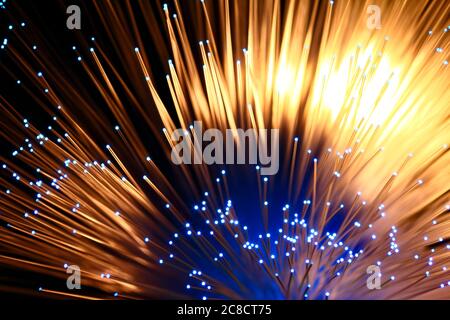 Fibre optic strands with light passing through creating a colourful abstract burst of light pattern Stock Photo