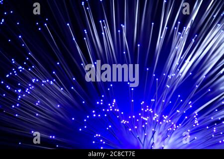 Fibre optic strands with light passing through creating a colourful abstract burst of light pattern Stock Photo