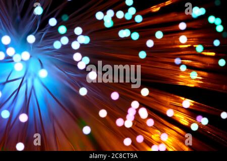Fibre optic strands with light passing through creating a colourful abstract burst of light pattern Stock Photo