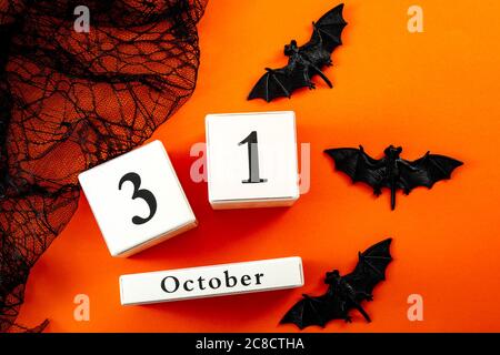 Happy Halloween and fall holiday concept with a calendar showing october 31, bats and black spider web Stock Photo