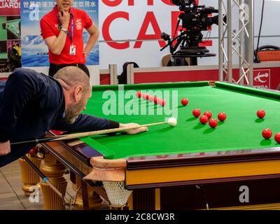 Male taking a snooker shot Stock Photo
