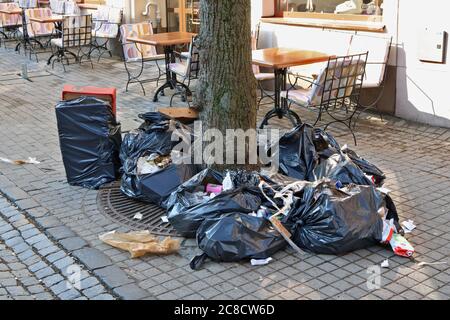 VILNIUS, LITHUANIA - MARCH 31, 2018:  An ugly landfill of garbage and waste near a cafe on Didzioji (Long or Large) street of Baltic capital Stock Photo