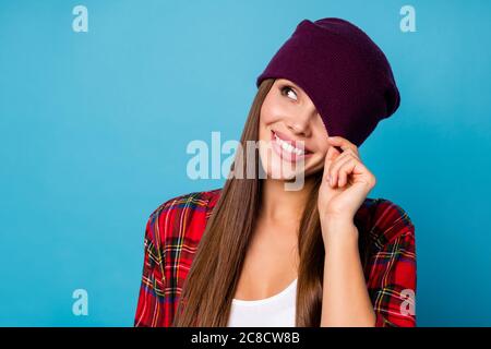 Closeup photo of good mood attractive funny lady close hide hat one eye flirty carefree look side up empty space dreamer wear casual hat plaid shirt
