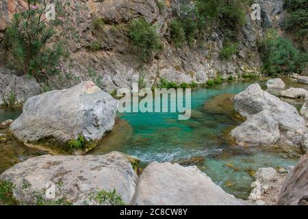 AKCHOUR, CHEFCHAOUEN, MOROCCO - Sep 01, 2018: Spring of fresh water passing through a valley or gorge and oleander trees in the mountains of Akchour M Stock Photo