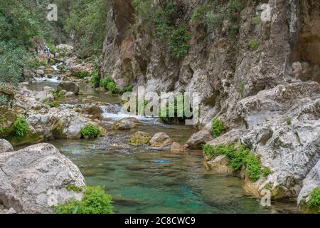 AKCHOUR, CHEFCHAOUEN, MOROCCO - Sep 01, 2018: Spring of fresh water passing through a valley or gorge and oleander trees in the mountains of Akchour M Stock Photo