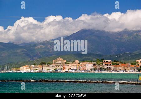 Golfe de Saint-Florent in Corsica: dramatic clouds over the town of St Florent and the mountains of Cap Corse Stock Photo