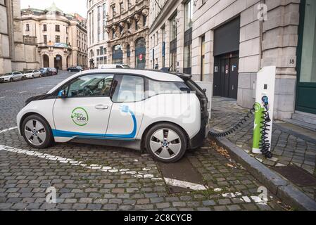 Zen electric car being charged in Brussels city centre on a winter day. Zen Car is the leader in electric car sharing in Belgium. Stock Photo