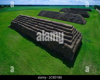 Aerial view of big pyramids made out of rectangular haystacks Stock Photo
