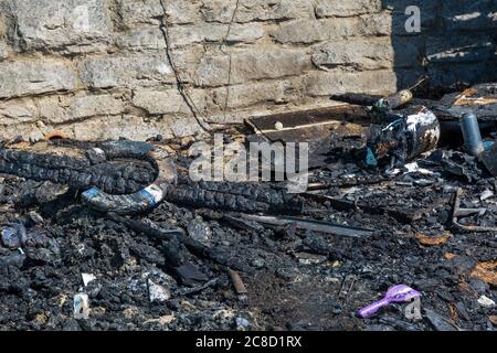 Not such a lucky horseshoe! Charred remains of beach huts destroyed in fire at West Cliff beach, Bournemouth, Dorset UK in July Stock Photo