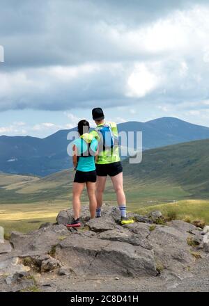 Hikers on top of a mountain with a magnificent view point Stock Photo