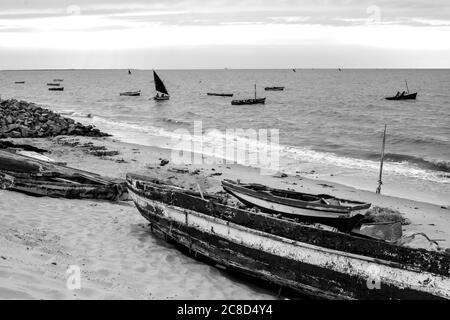 Weatherd dhows on the sandy beach at a small fishing harbor in Maputo, Mozambique, in the early morning, photographed in monochrome Stock Photo