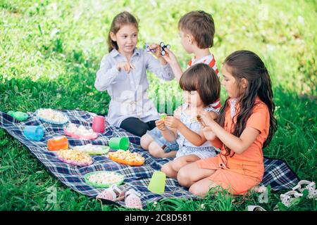 Three happy smiling child playing in park Stock Photo