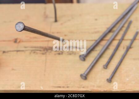 Construction nails during the construction of a wooden house. Building accessories nails Stock Photo