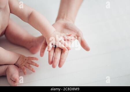 Father holds his little baby feet close up