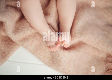 Father holds his little baby feet close up
