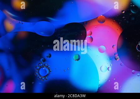 Abstract background with vibrant colours. Oil drops in water. Close colorful and artistic bubbles. Space pattern. Stock Photo