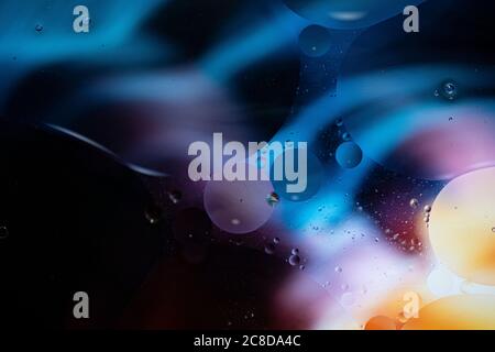 Abstract background with vibrant colours. Oil drops in water. Close colorful and artistic bubbles. Space pattern. Stock Photo