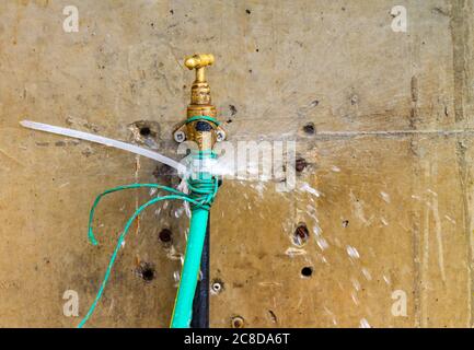 Leaking fresh water tap leaking hose pipe Stock Photo