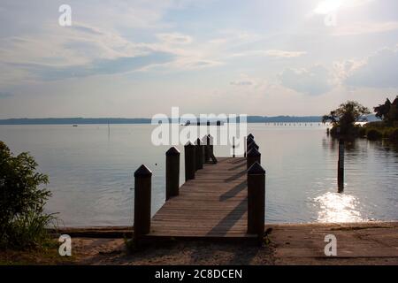A view of the Mallows bay by Potomac River on a sunny day. Image is featuring a boat ramp and a wooden pier with docking posts. This place is home to Stock Photo