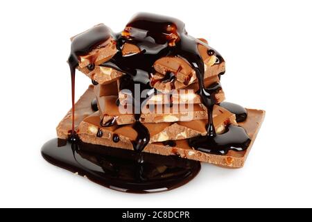 chocolate syrup being poured on chocolate pieces isolated Stock Photo