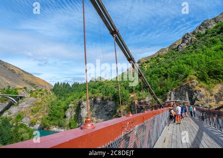 Tourists waiting to do a bungy jump from Kawarau Gorge suspension bridge, Otago, New Zealand. The bridge was the worlds first commercial bungee site. Stock Photo